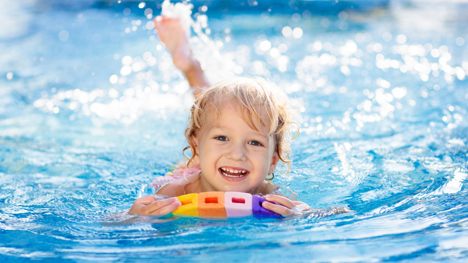 Learn to swim & water safety Child having fun during swimming lessons